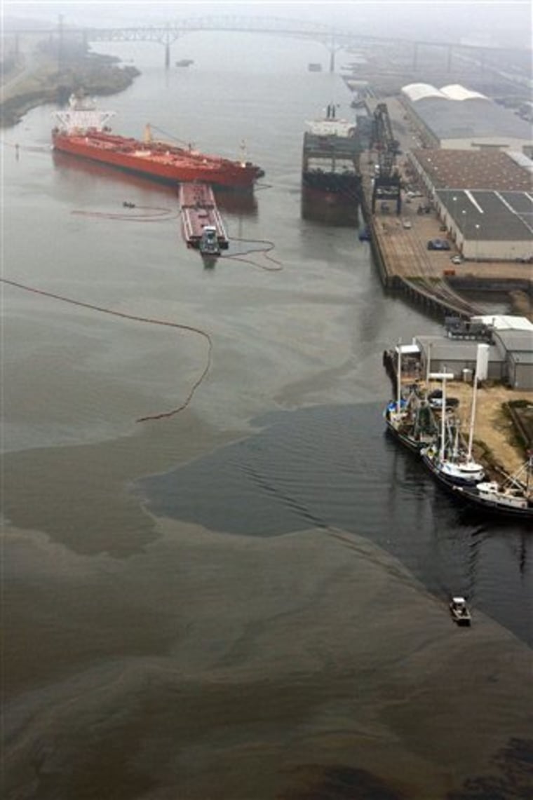 A barge is seen engaged with Eagle Otome after the two vessels collided causing as much as 450,000 gallons of crude oil to spill, according to the U.S. Coast Guard, on Saturday, Jan. 23, 2010, in Port Arthur, Texas.  Officials contained the spill, but were still assessing the scope and cause. No injuries were reported from the collision. (AP Photo/Houston Chronicle, Julio Cortez) MANDATORY CREDIT